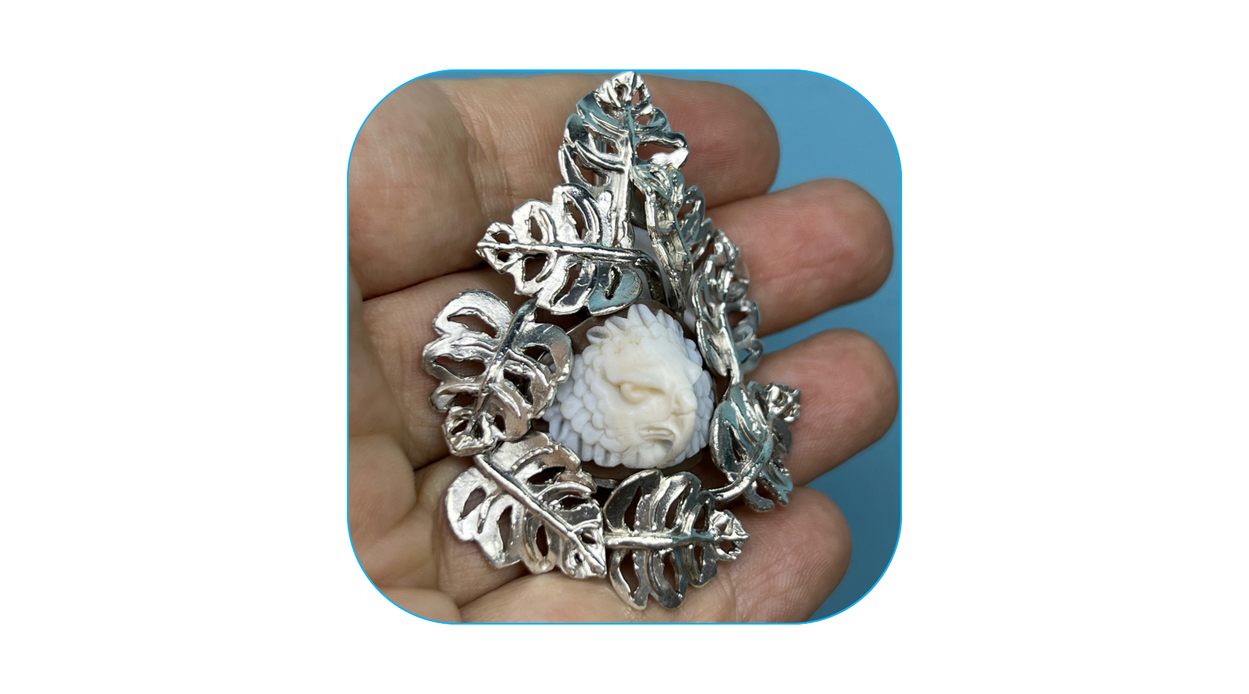 image of wounaan carved harpy eagle cameo with sterling silver palm fronds adorning it 