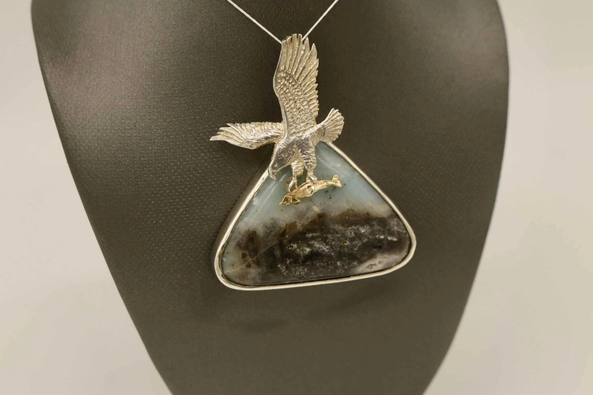 soaring eagle with fish in silnova atop agate gemstone