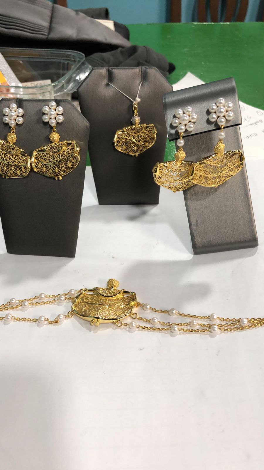 collection of gold plated filigree pollera dancer pendant, earrings and bracelet