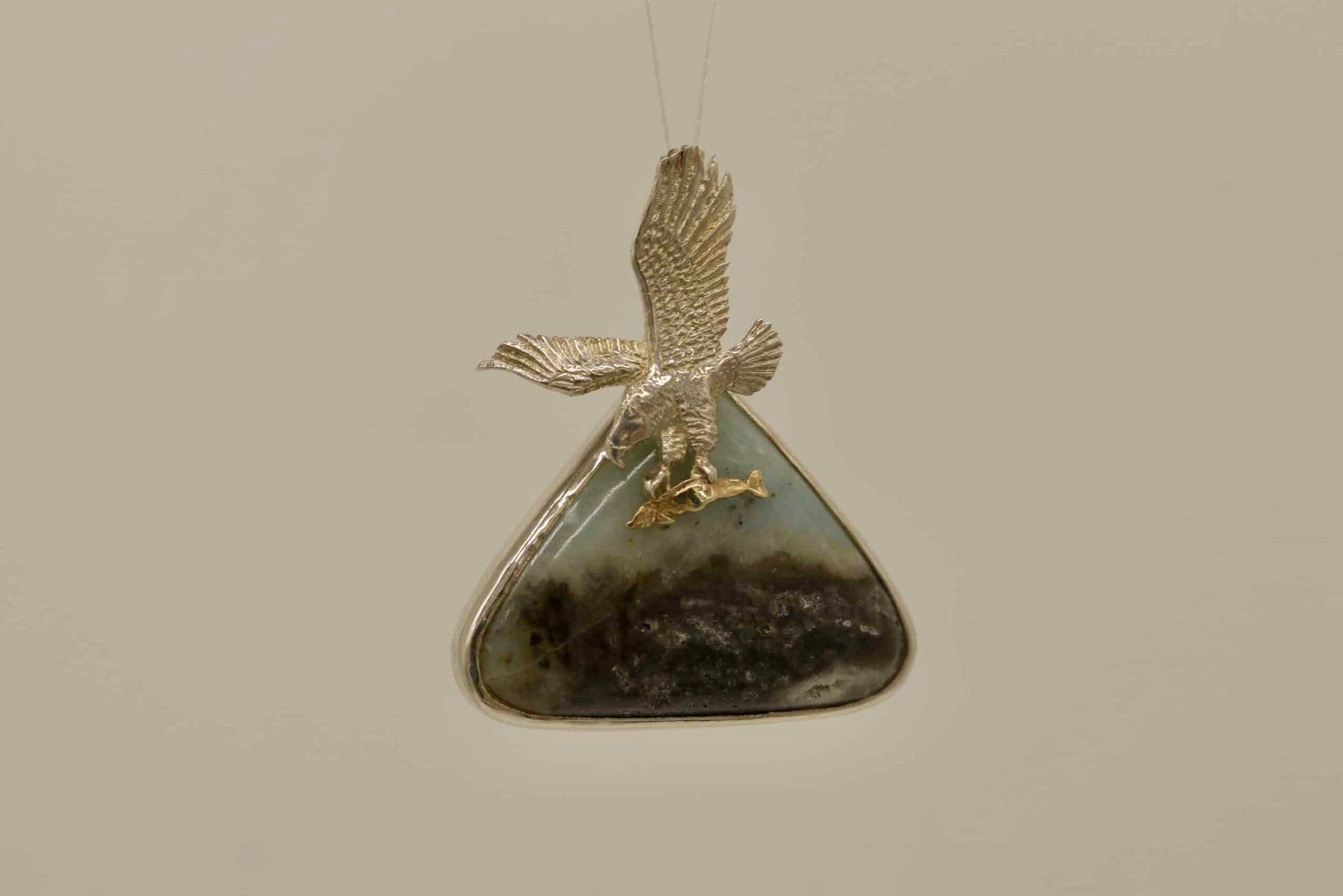 soaring eagle with fish in silnova atop agate gemstone